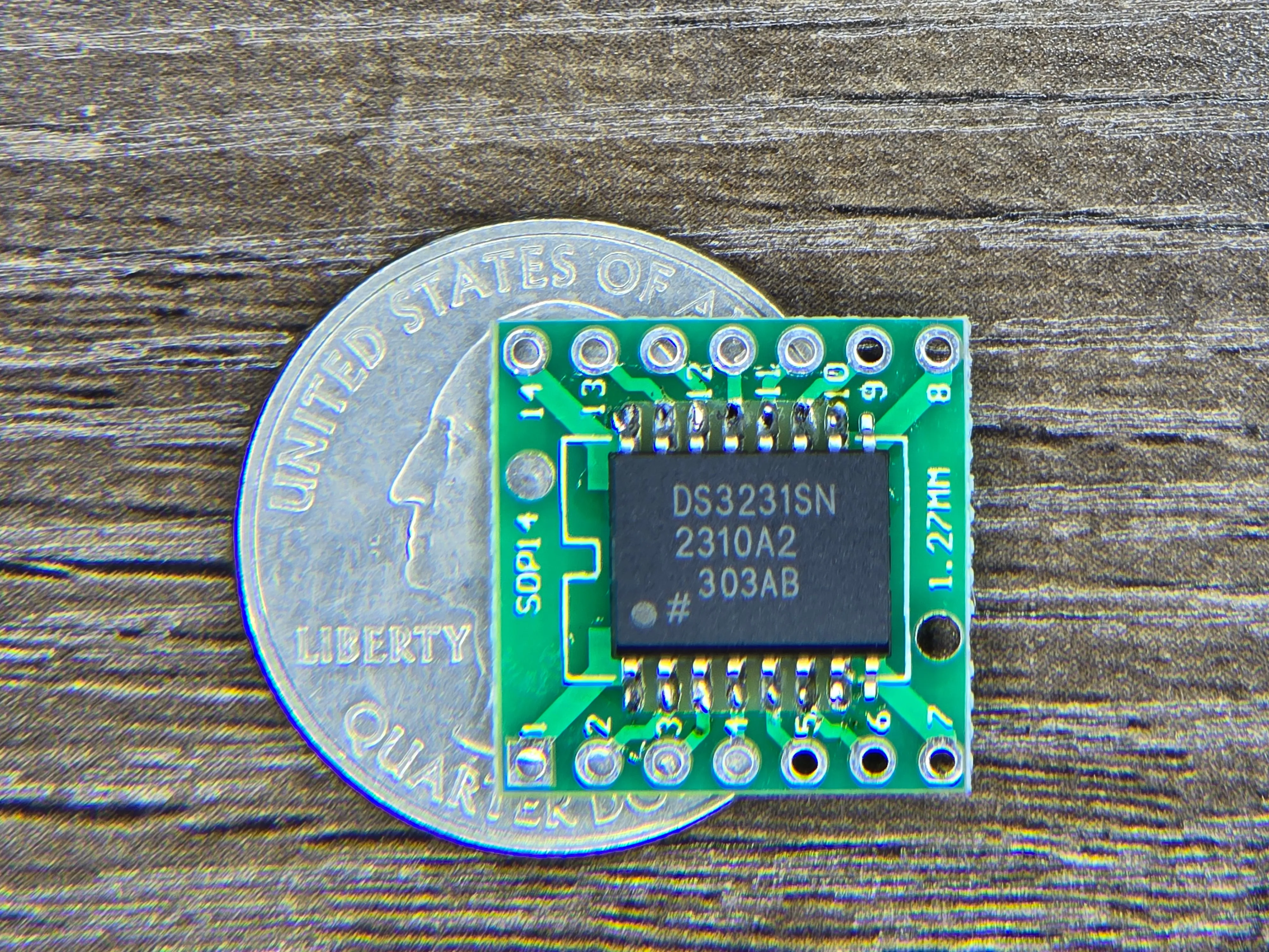 DS3231 RTC chip on a SOP14 adapter board next to a quarter for scale
