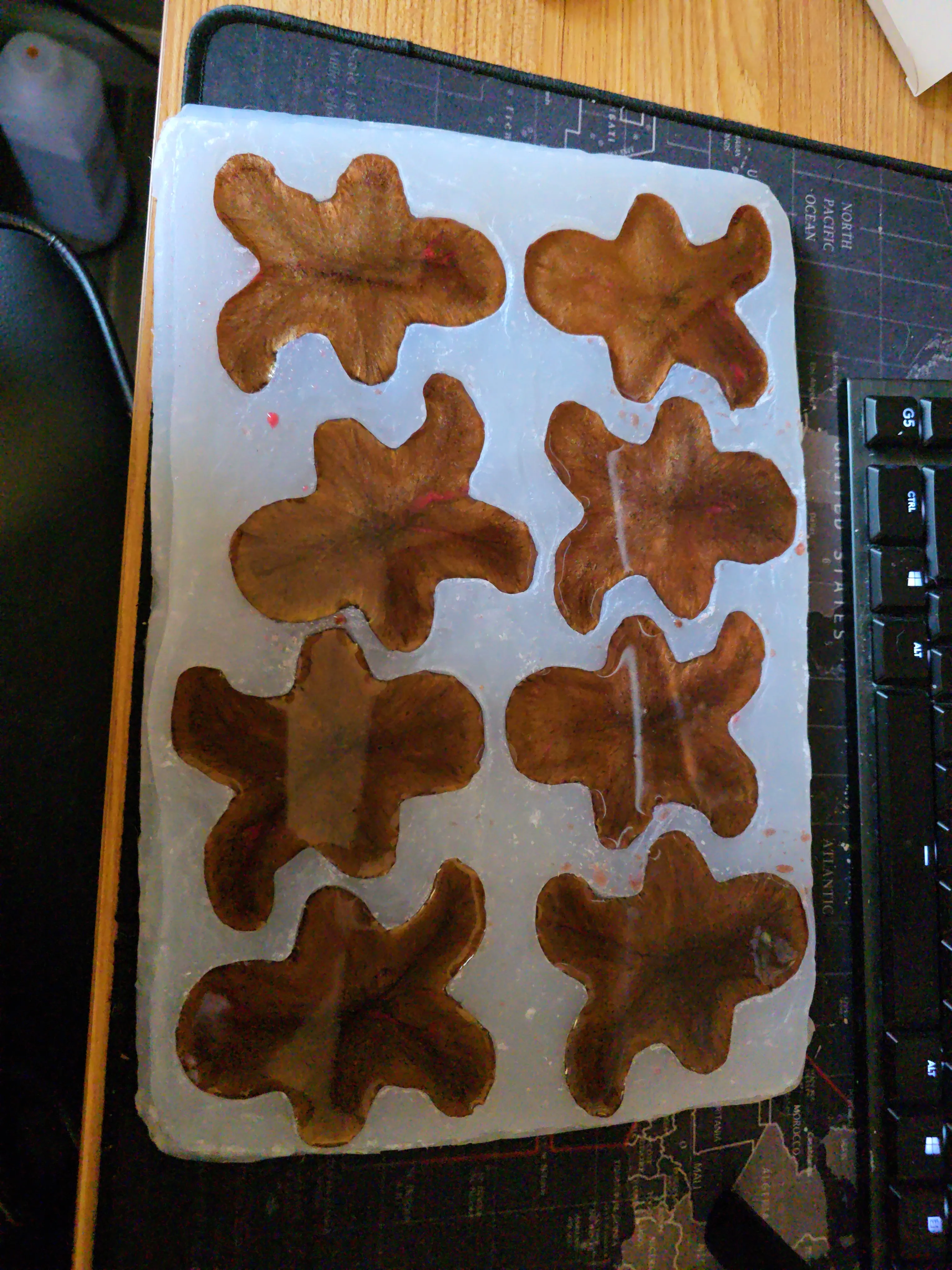 Eight gingerbread ornaments curing in a silicone mold