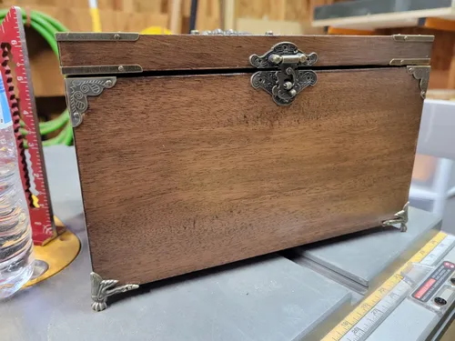 Finished mahogany jewelry box shown at an angle showing hinges and clawed feet