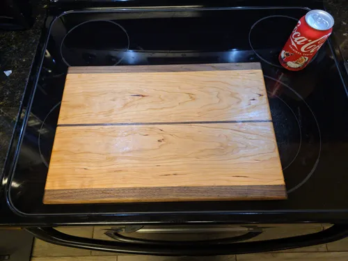 Cherry cutting board with a centered walnut stripe