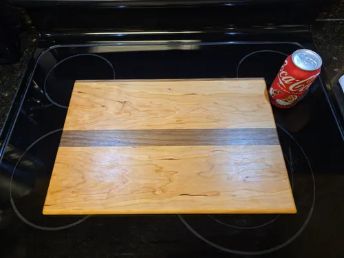 Cherry cutting board with an off-center walnut stripe