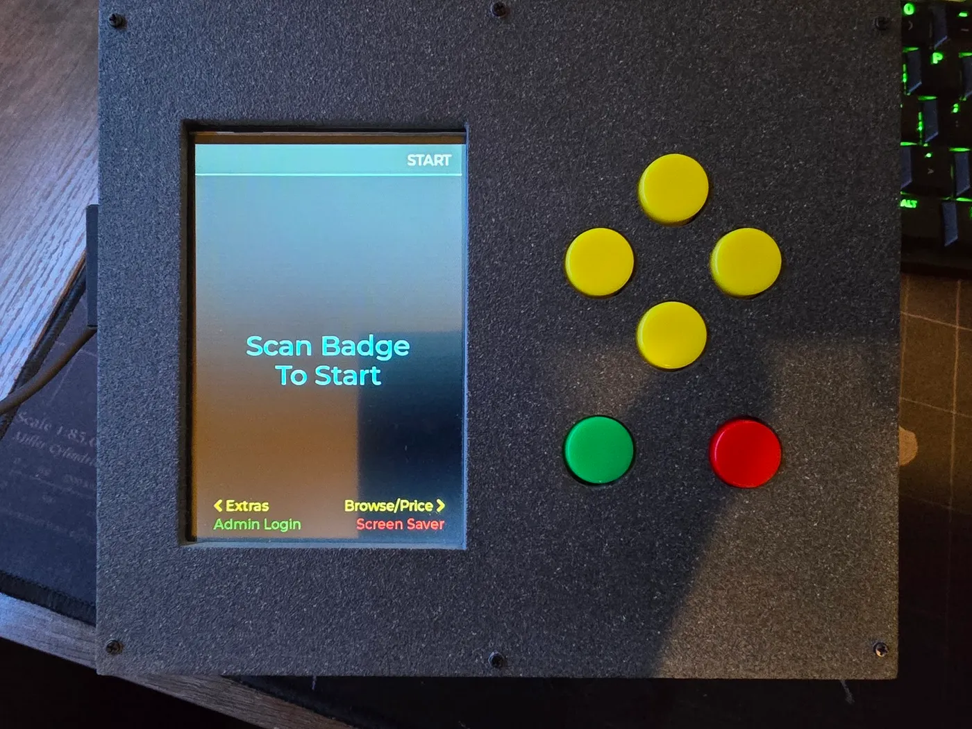The finished snack cart terminal switched on, showing "Scan Badge To Start" beside its yellow direction buttons and green and red Enter and Back buttons