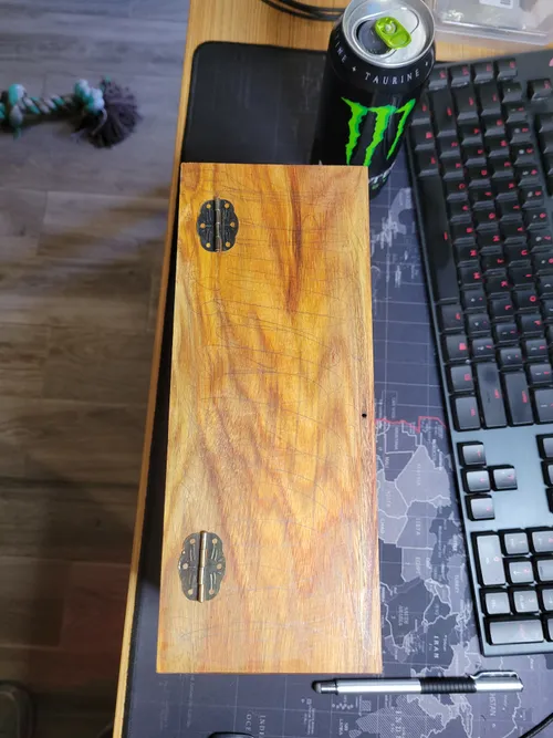 Brass hardware laid out on the box lid for placement