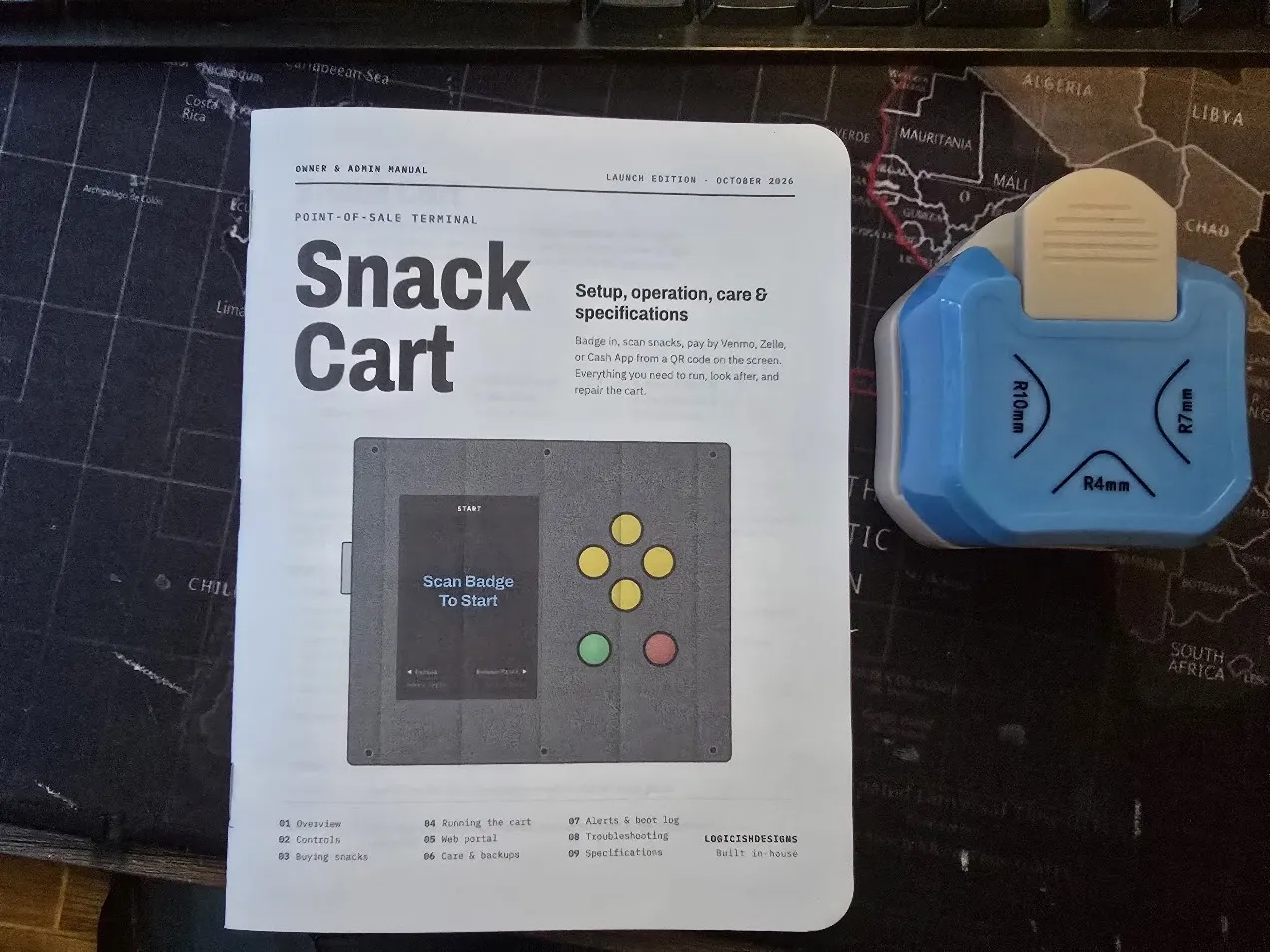The finished manual with rounded corners next to the corner-rounding punch