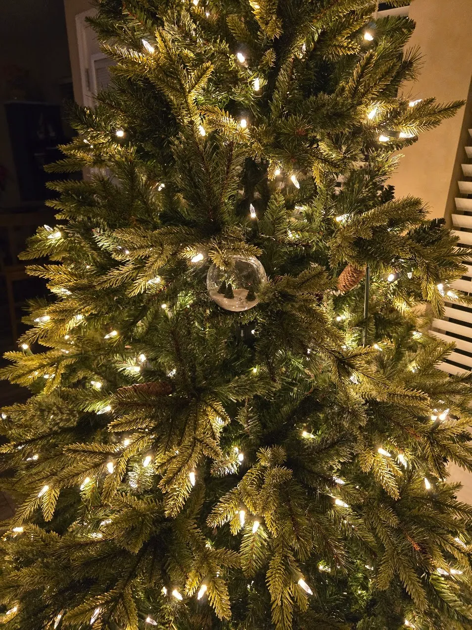 The finished ornament hanging on a lit Christmas tree